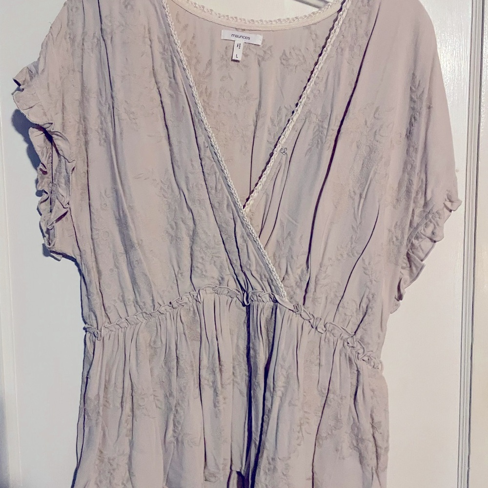 Lightweight floral embossed peplum blouse. Snap at vneck.
